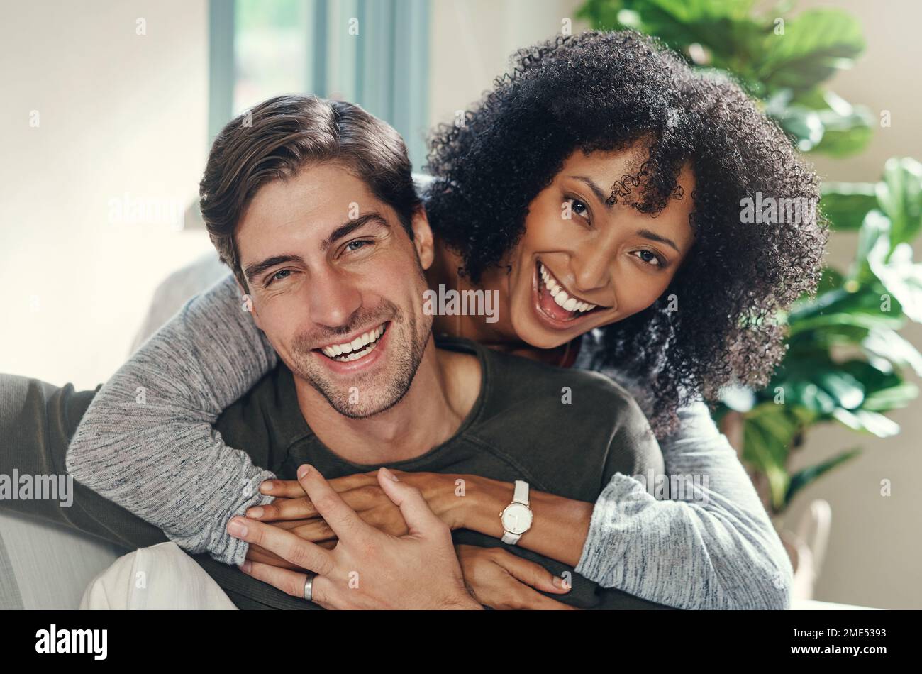 We bring love and happiness into each others lives. Portrait of an affectionate young couple spending some quality time together in their living room Stock Photo