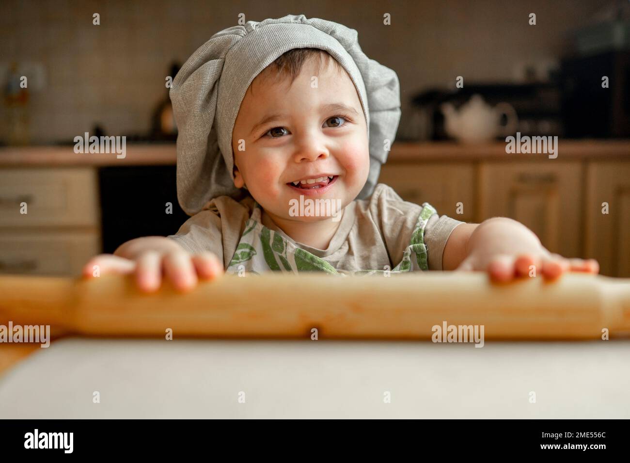 Happy boy wearing chef's hat in kitchen Stock Photo Alamy