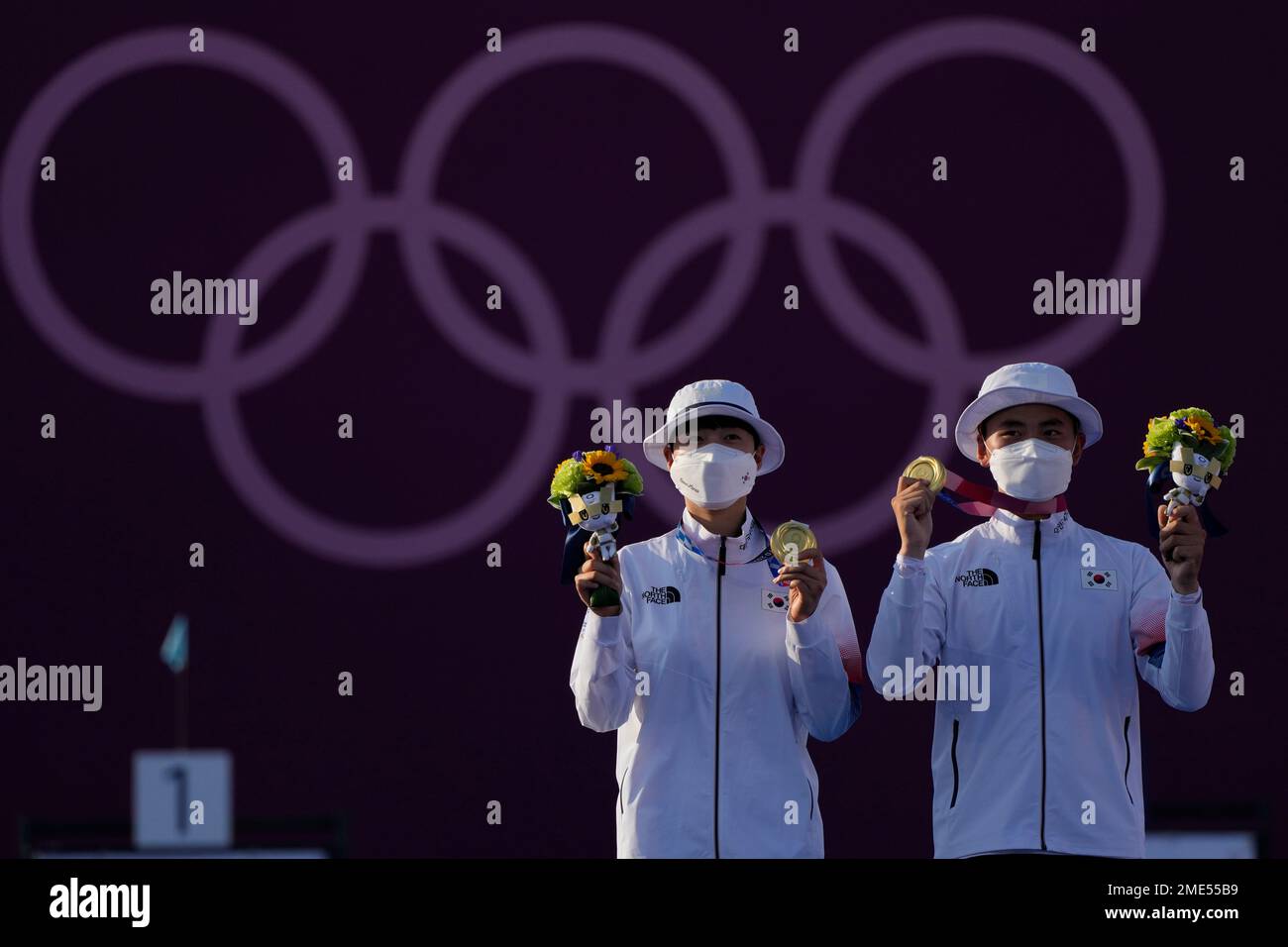Gold medal winners South Korea's An San, left, and South Korea's Kim Je