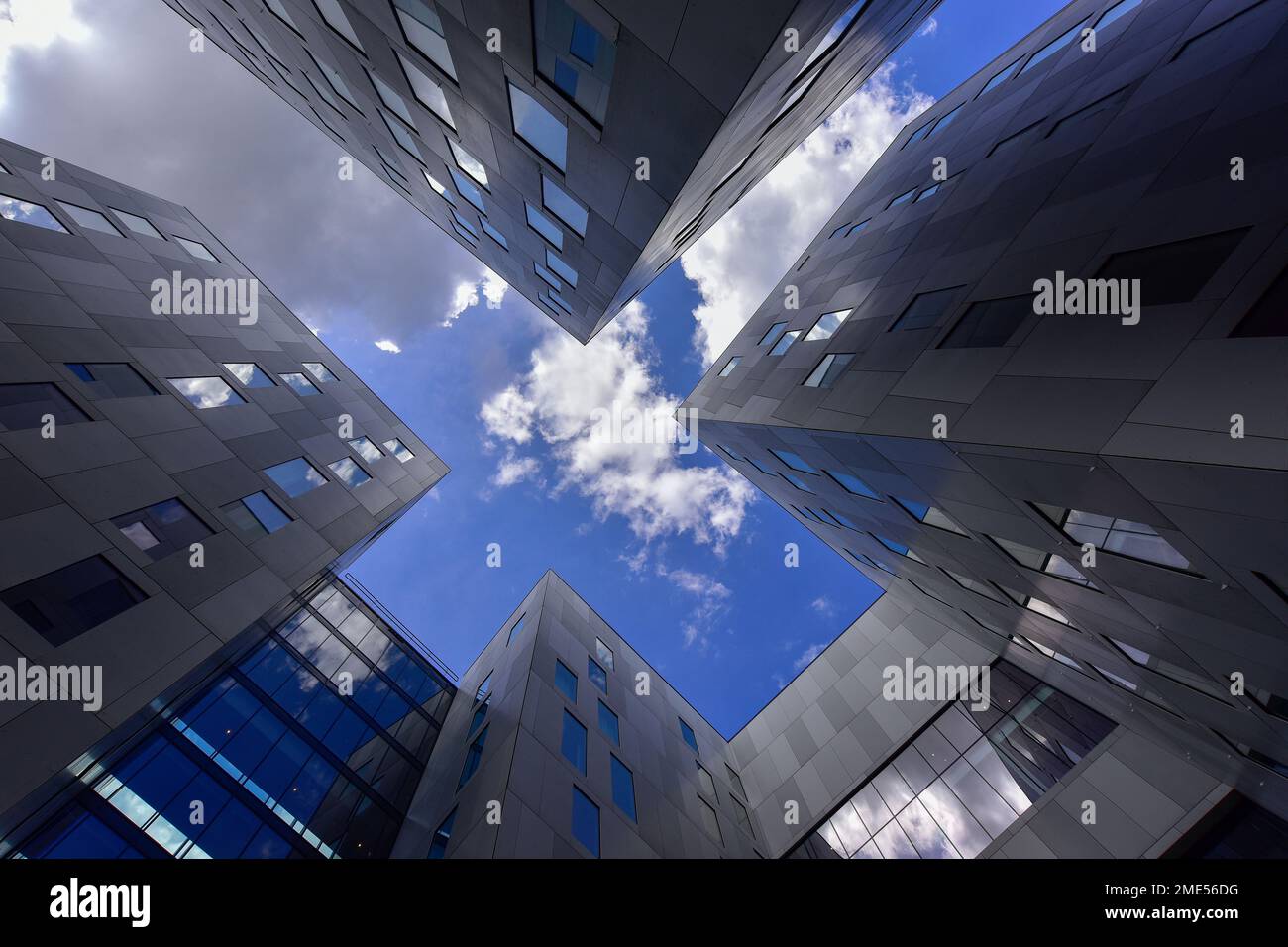 Netherlands, North Holland, Amsterdam, Directly below view of sky over gray modern buildings Stock Photo
