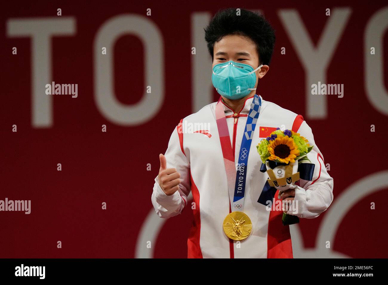 Hou Zhihui of China celebrates on the podium after winning the gold