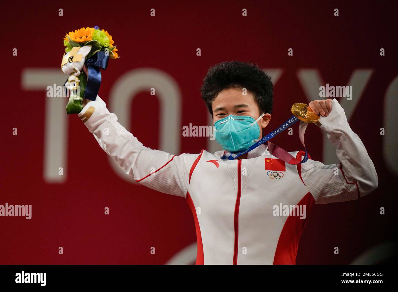 Hou Zhihui of China celebrates on the podium after winning the gold