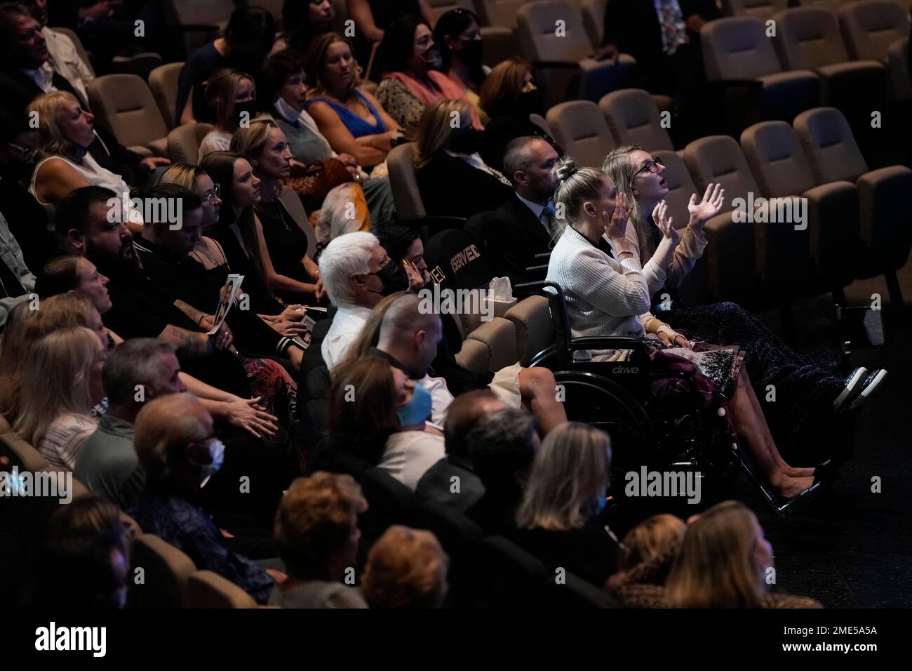 Angela Gonzalez, second from right, and daughter Deven, right, attend