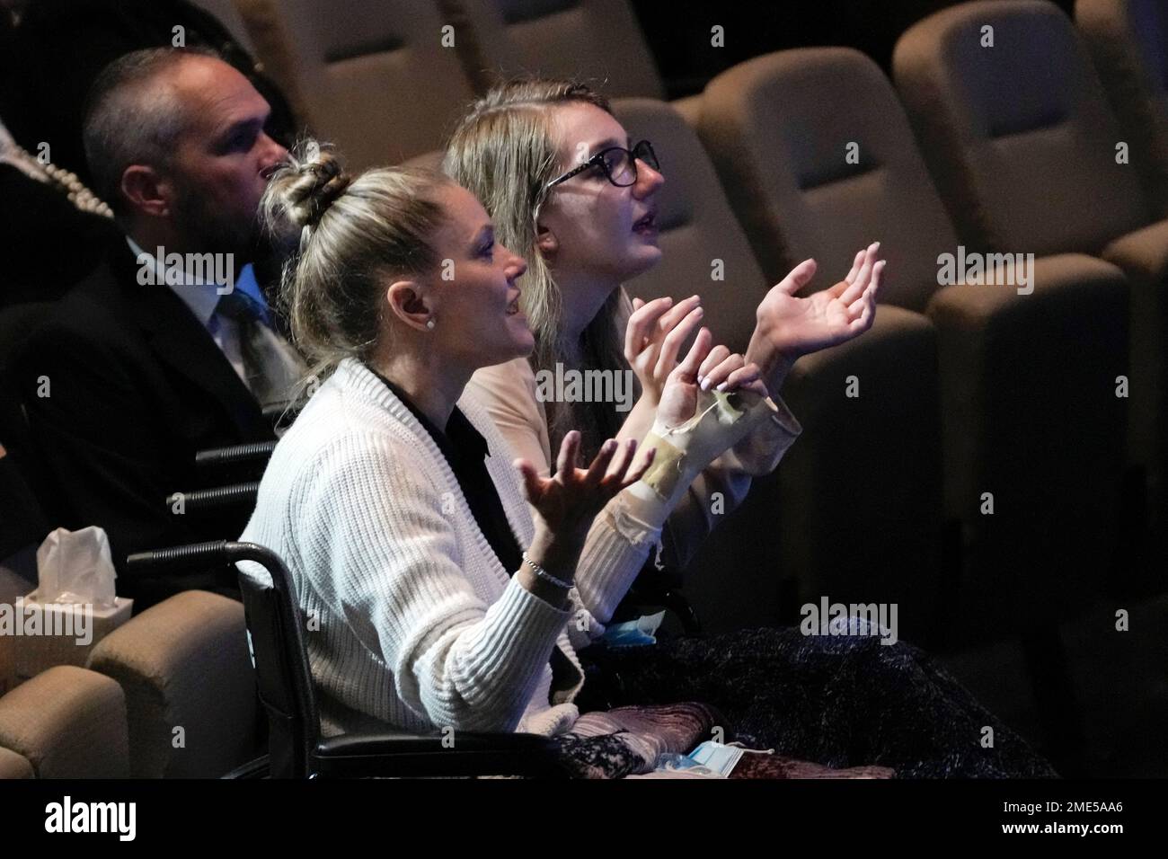 Angela Gonzalez, left, and daughter Deven Gonzalez sing in prayer