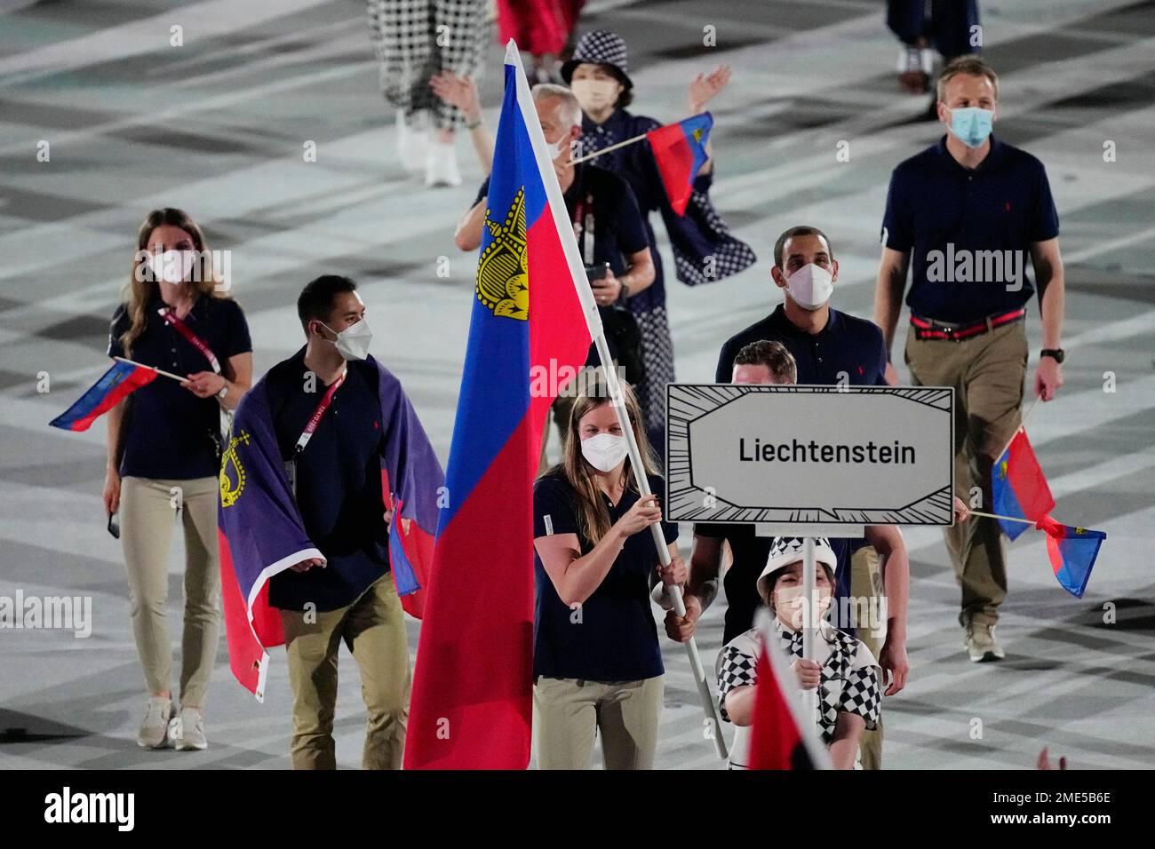 Julia Hassler and Raphael Schwendinger, of Liechtenstein, carry their ...