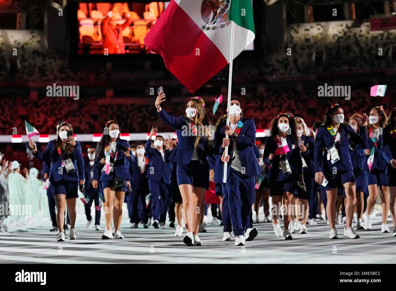 Gaby Lopez and Rommel Pacheco Marrufo, of Mexico, carry their country's ...