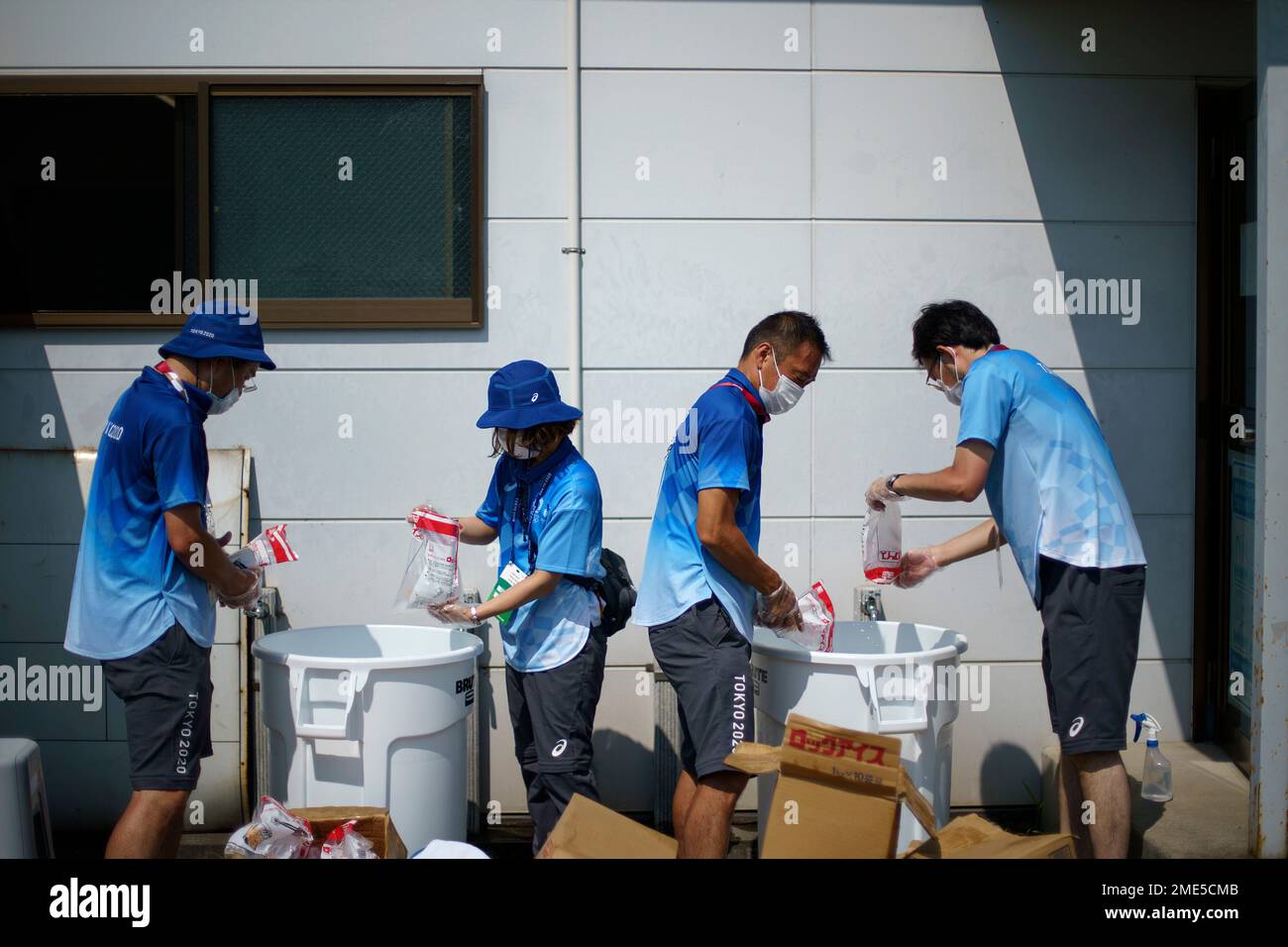 Workers prepare ice baths in garbage bins for players before a men's ...