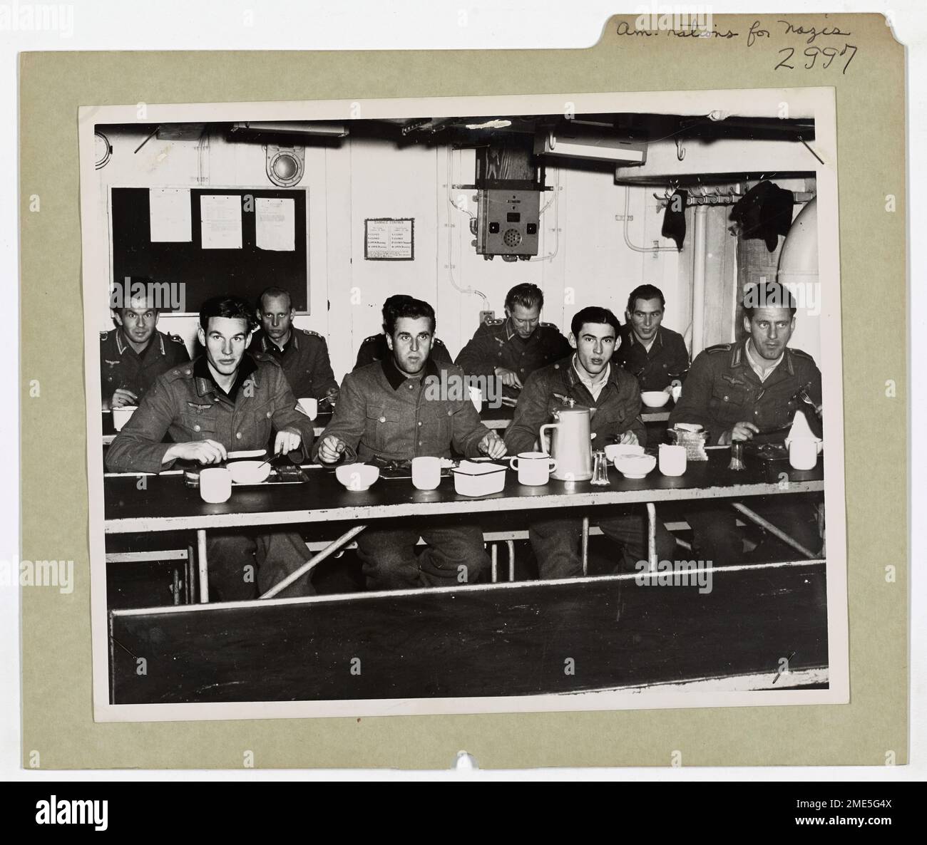 American Rations Taste Good To Nazis Captured in Surprise Greenland Attack. This image depicts Nazi prisoners of war brighten up a bit when they sit down to American Rations after being captured in a surprise Greenland action. Stock Photo
