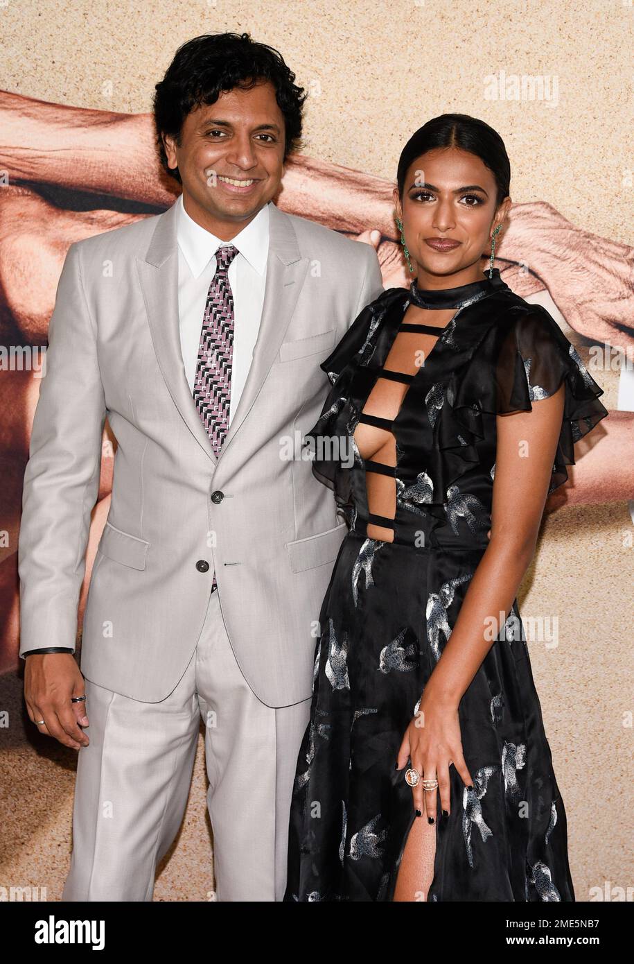 Director M. Night Shyamalan, left, poses with his daughter and second