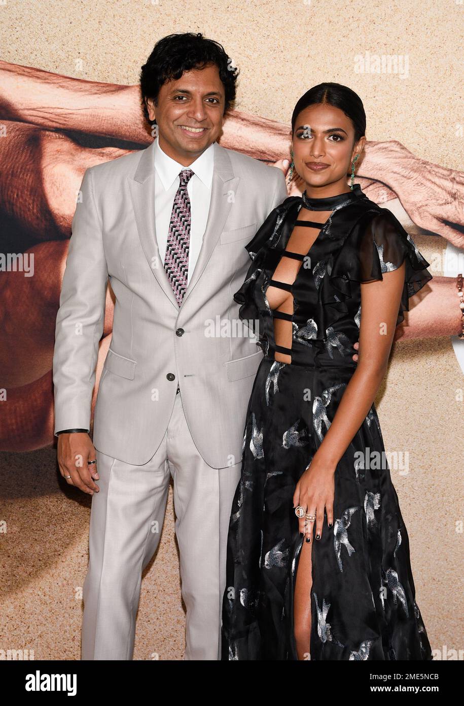 Director M. Night Shyamalan, left, poses with his daughter and second