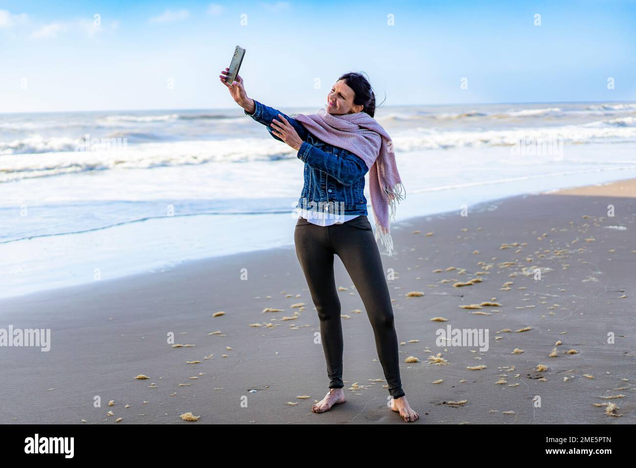 Portrait of a woman taking selfies on the beach Stock Photo