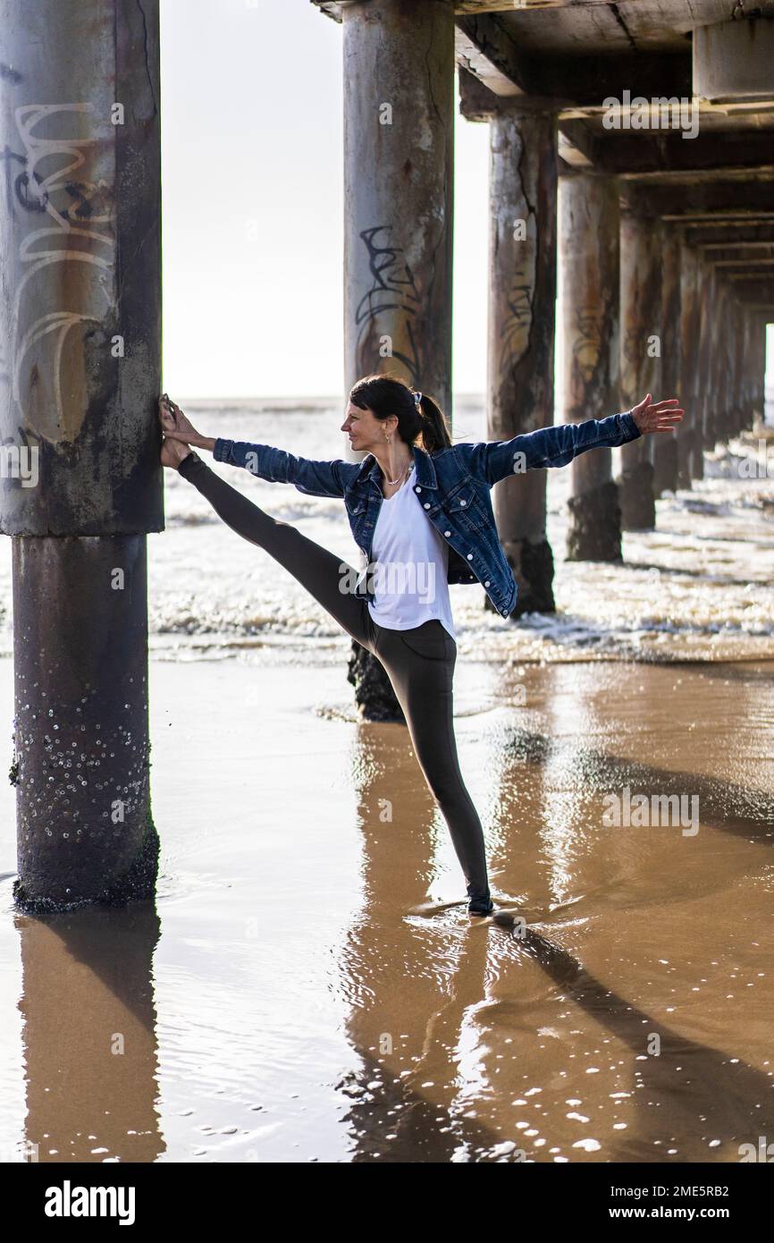 A woman doing stretching exercises outdoors Stock Photo - Alamy