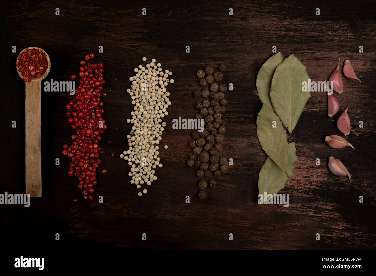 Spices and herbs on a dark background. Stock Photo