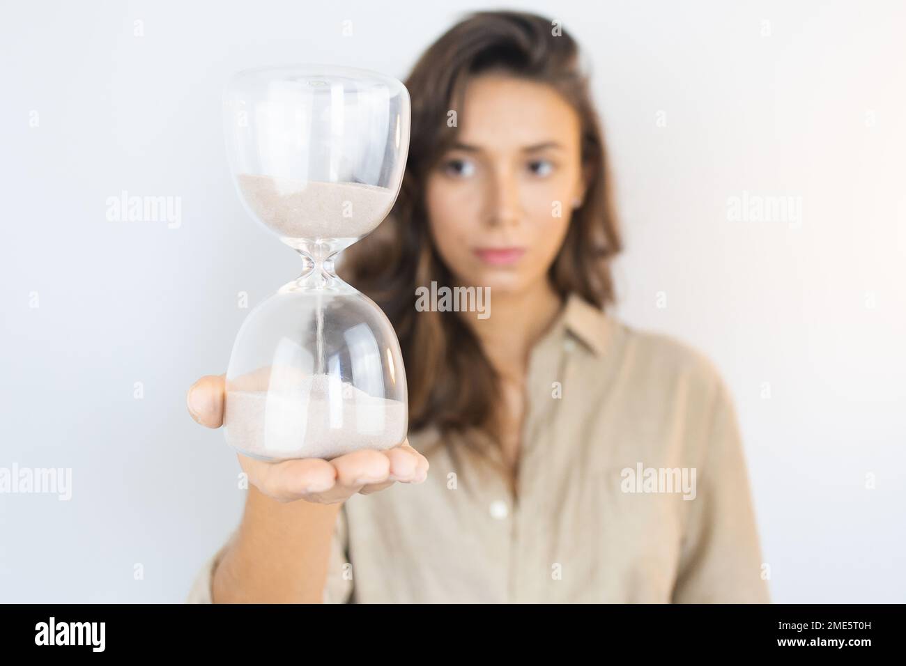 Young Woman Holding an Hourglass Aging Stock Photo