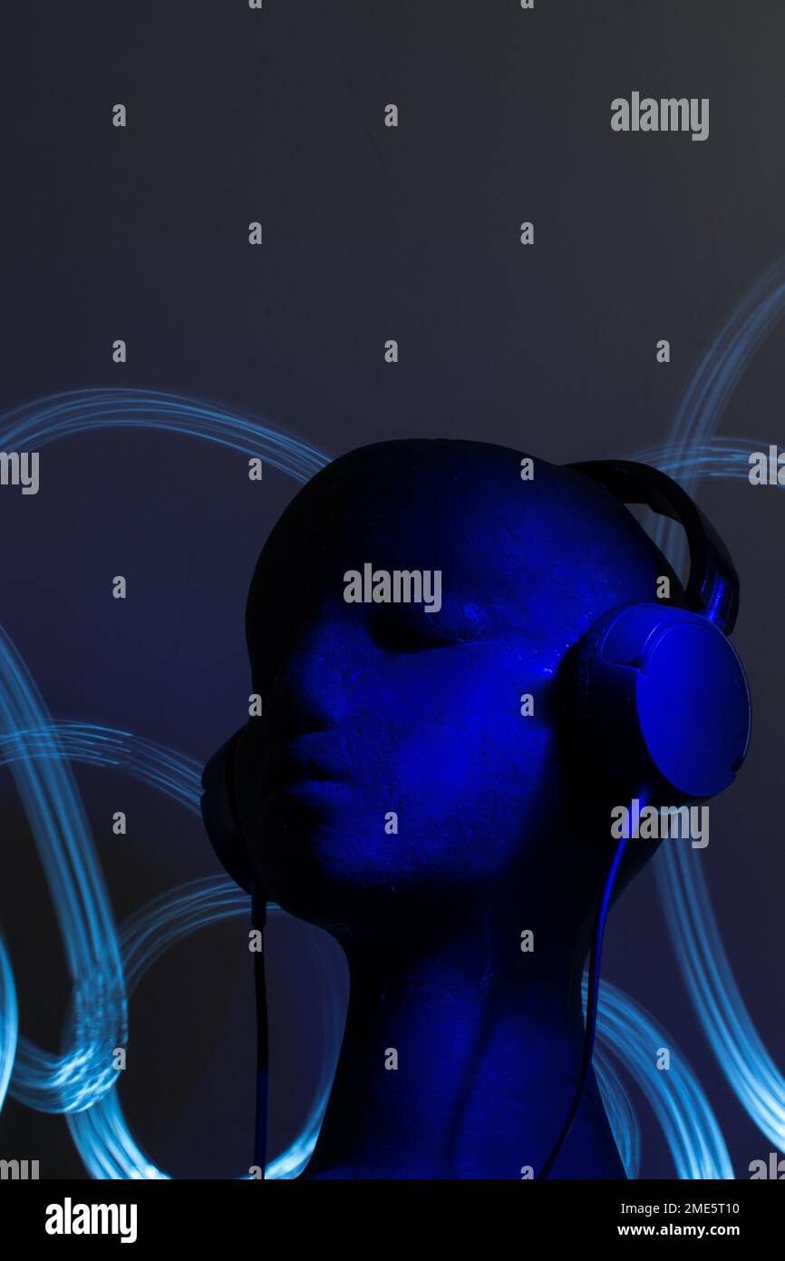 Blue light blue over-ear headphones on black head Stock Photo