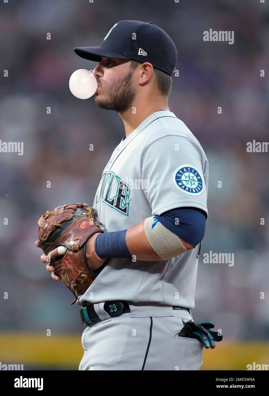 Seattle Mariners first baseman Ty France blows a bubble during the fifth  inning of the team's baseball game against the Colorado Rockies on Tuesday,  July 20, 2021, in Denver. (AP Photo/David Zalubowski
