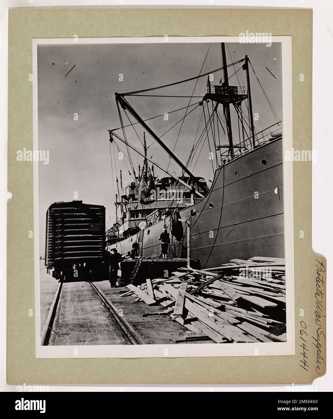 Coast Guard Protects War Supplies. War supplies bound for Allied troops on far flung shores around the world are loaded aboard a merchant ship under the watchful eyes of Coast Guard sentries. Stock Photo