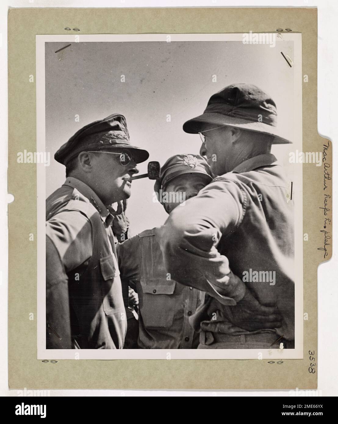 MacArthur Keeps His Pledge. This remarkable study of General Douglas MacArthur, nonchalantly puffing on his corncob pipe, was made by a Coast Guard combat photographer at the historic moment when MacArthur surveyed the Leyte Island Beachhead and saw his famous 'I will return' pledge fulfilled. Stock Photo