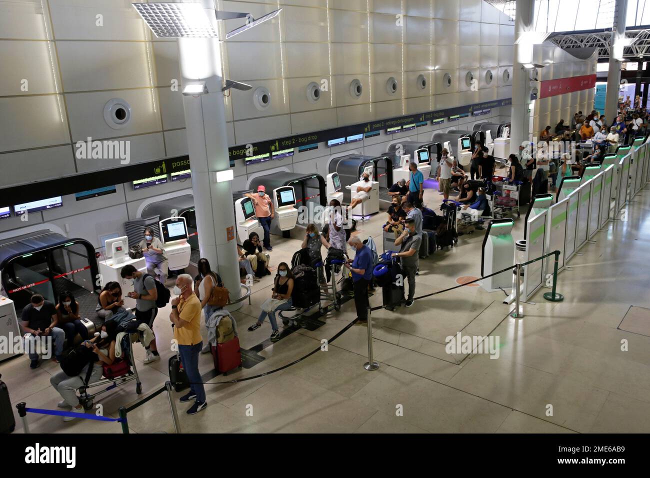 Passengers queue to reach the counter of TAP Air Portugal airline, at  Lisbon airport, Saturday, July 17, 2021. A strike by ground handling  workers at Portugal's airports forced the cancellation of over