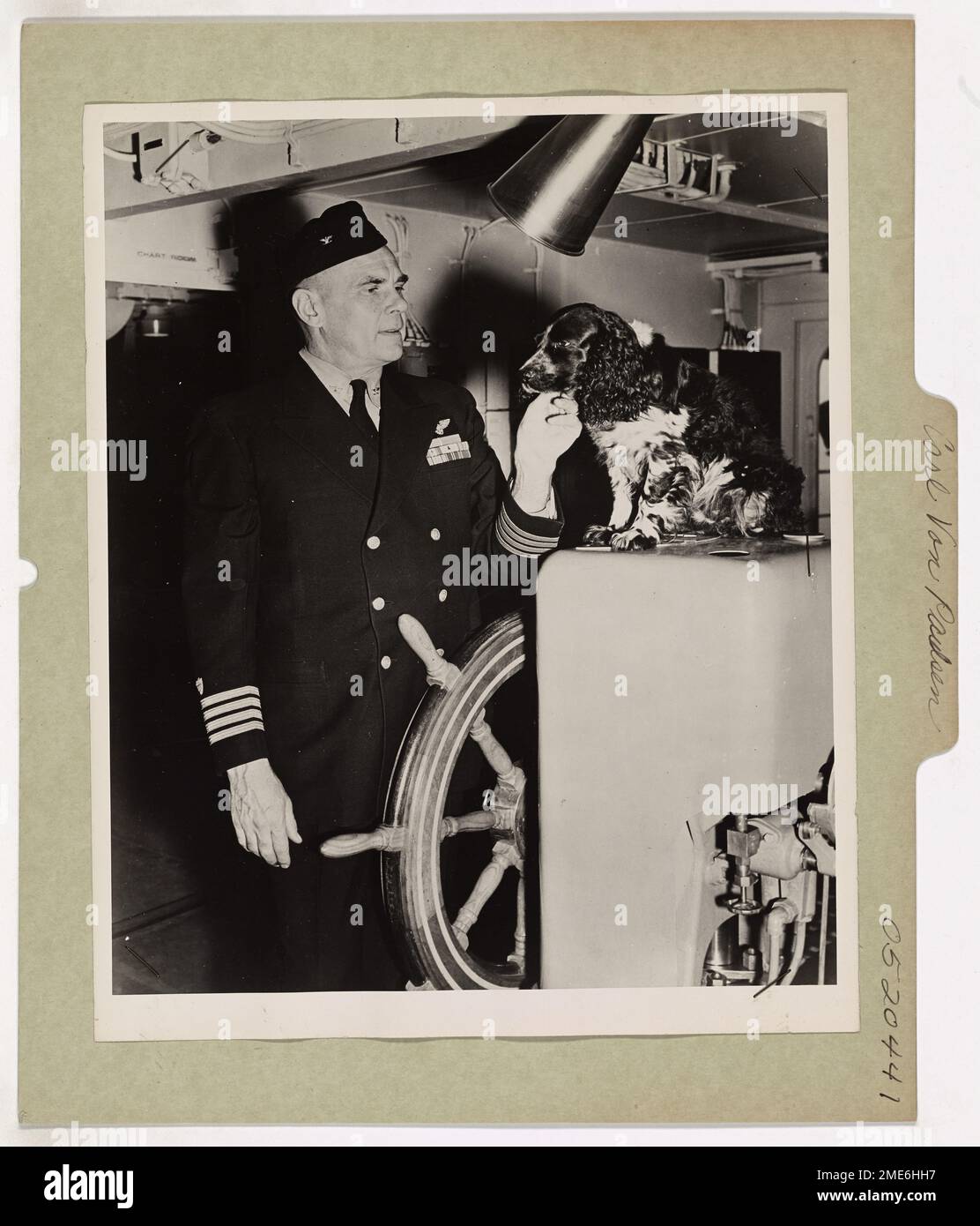 A black and white cocker spaniel rests on the bridge of a Coast Guard ...