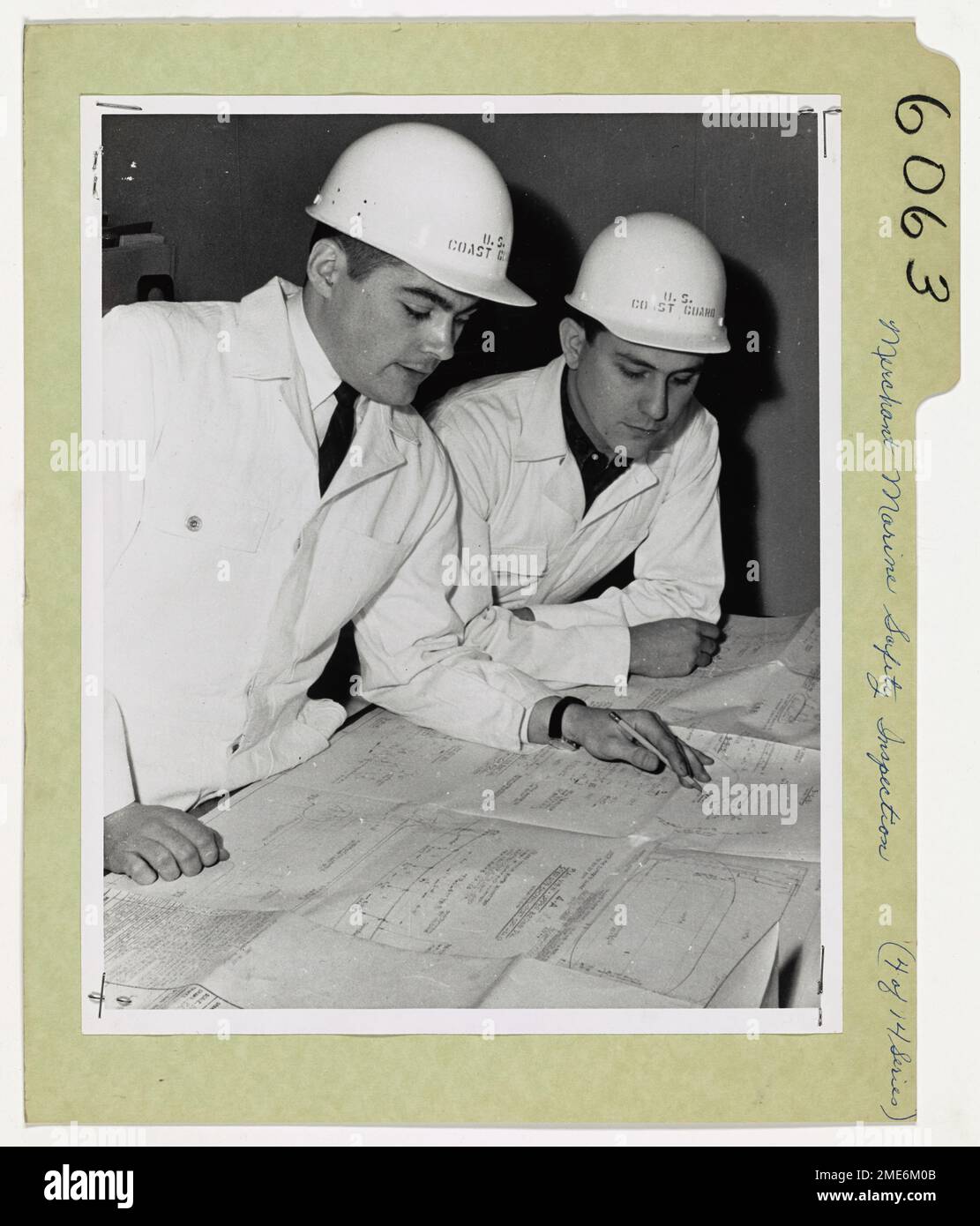 Preventing Sea Disasters in the Coast Guard's Business. Coast Guard marine inspectors, (left) Lieutenant Paul M. Hureau and Lieutenant Joel D. Sipes, study the plans of the newly built Grace Line passenger and cargo ship SS Santa Mercedes before boarding for inspection of her fittings while she is still in dry-dock at the Bethlehem Steel Shipyard at Sparrows Pt., Baltimore, Md. Stock Photo