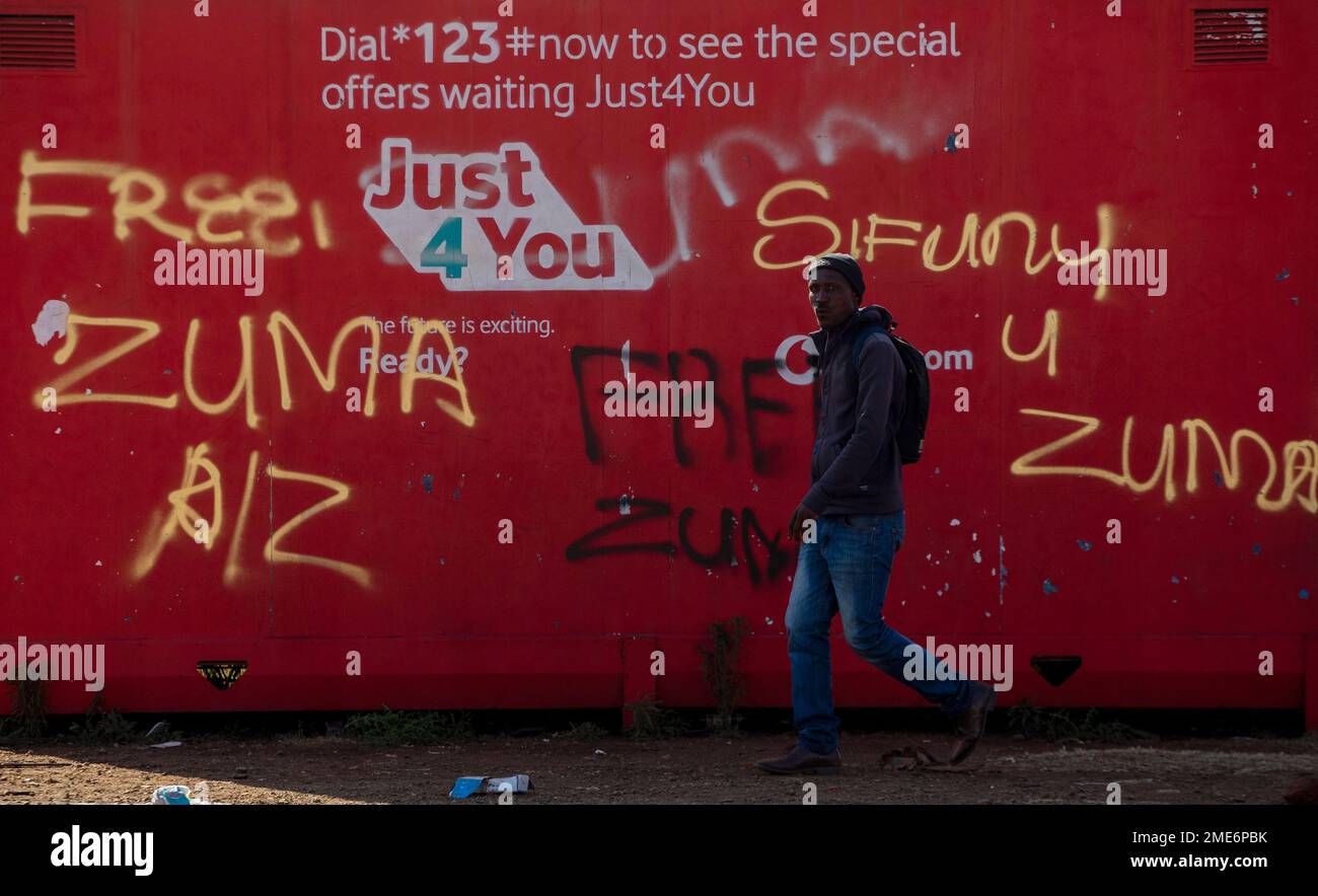 Zuma Reading A man walks past graffiti reading