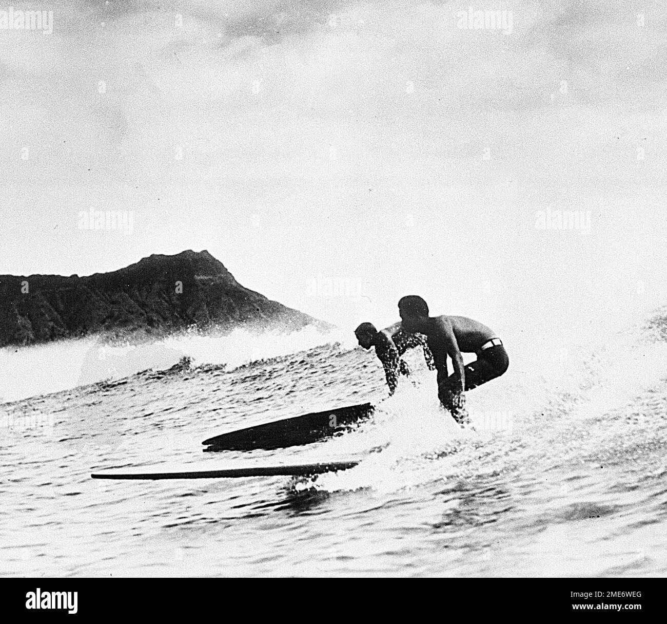 FILE In this Jan. 9, 1935, file photo, two surfers ride the crest of