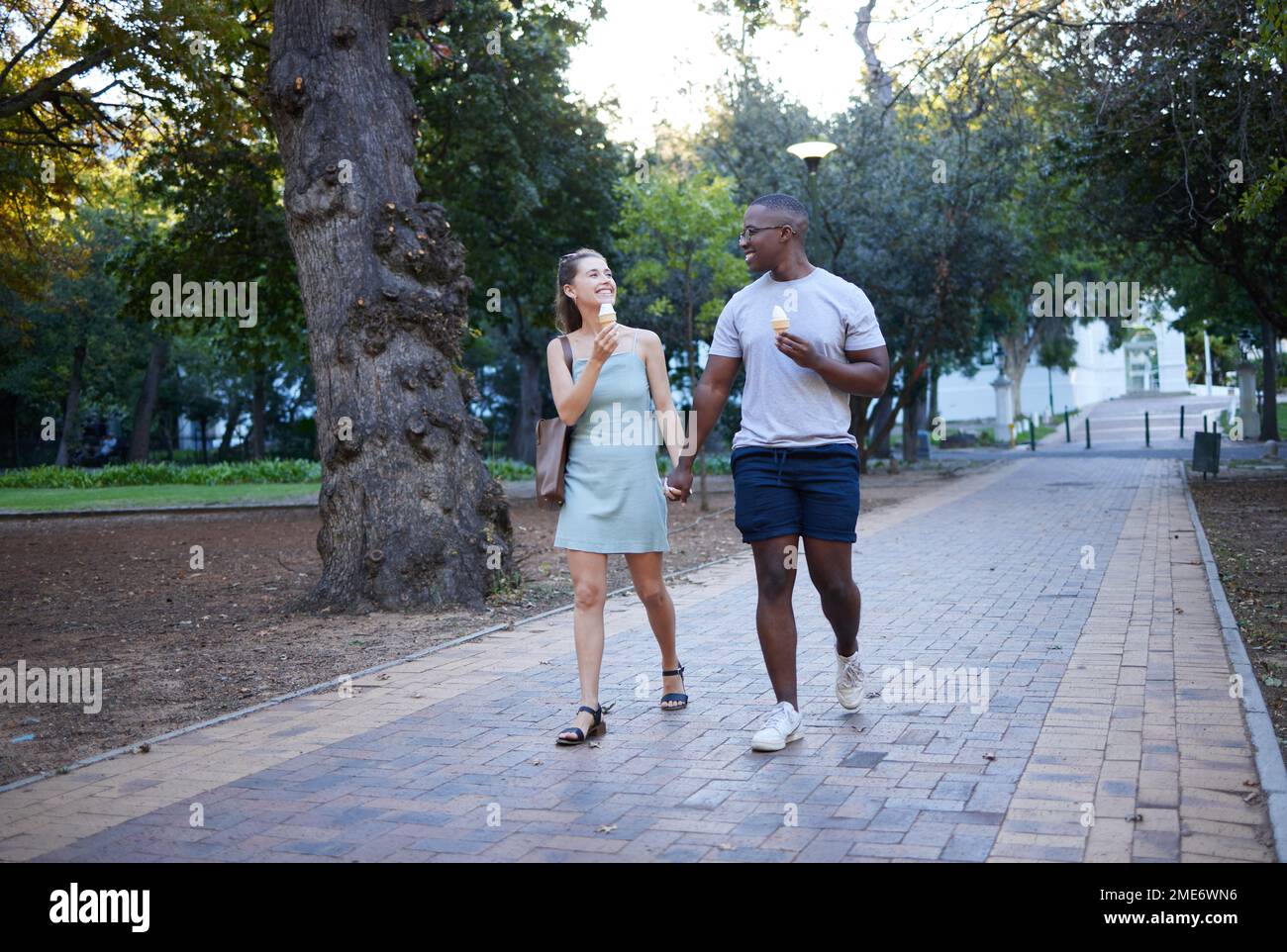 Couple on date in park, ice cream and holding hands outdoor, love and ...