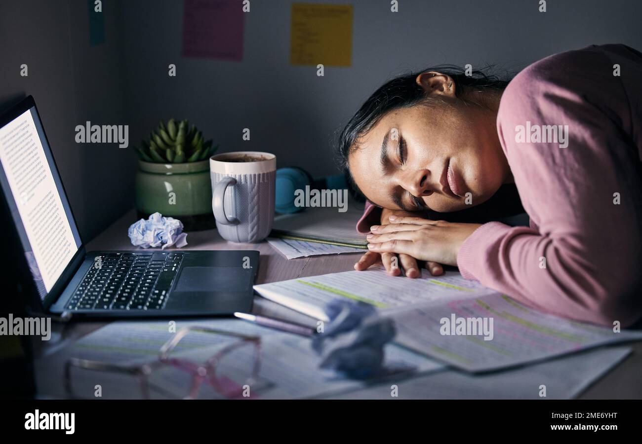 Sleeping, tired and fatigue student at night for study, learning and university depression, mental health or burnout on laptop. Depressed, stress and Stock Photo