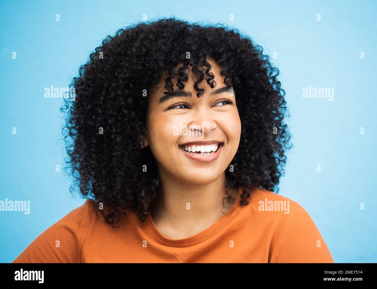 Black woman, happy and thinking face in blue background studio for empowerment support, positive mindset and confident. Young african girl, smile and Stock Photo