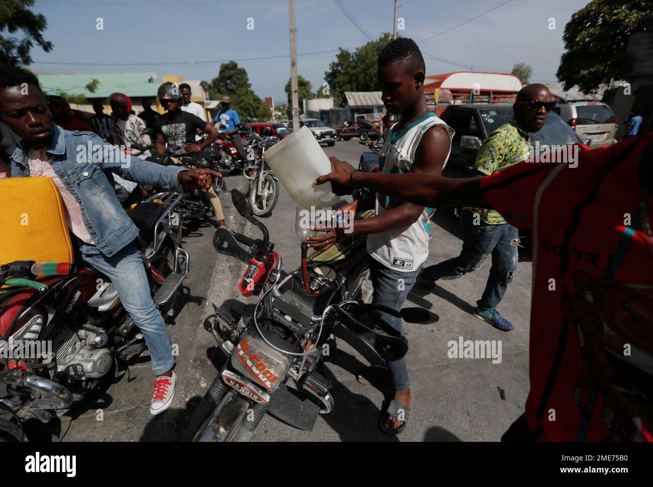 People fuel up their motorcycles in PortauPrince, Haiti, Sunday, July