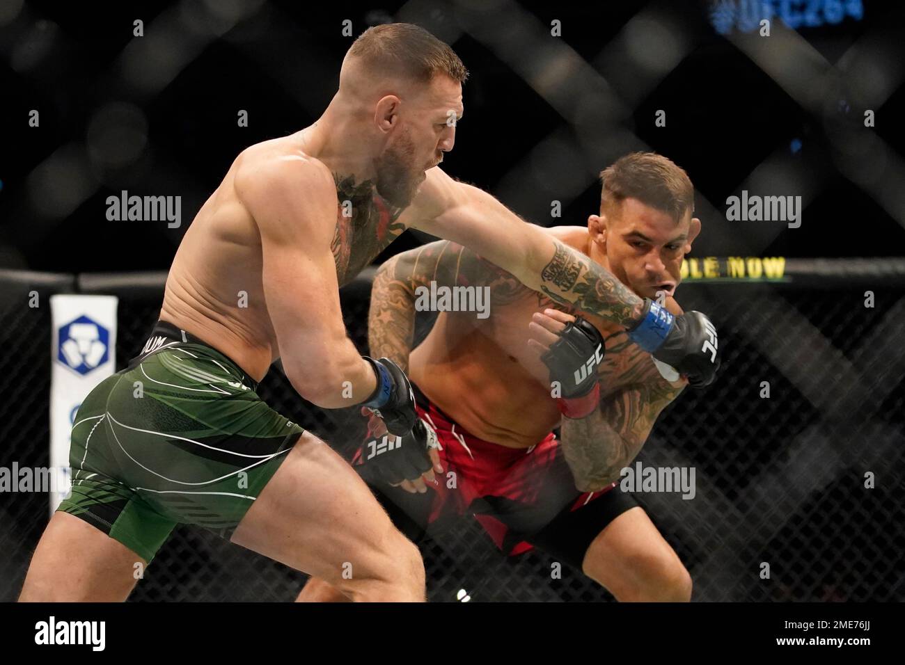 Conor McGregor, left, punches Dustin Poirier during a UFC 264 ...