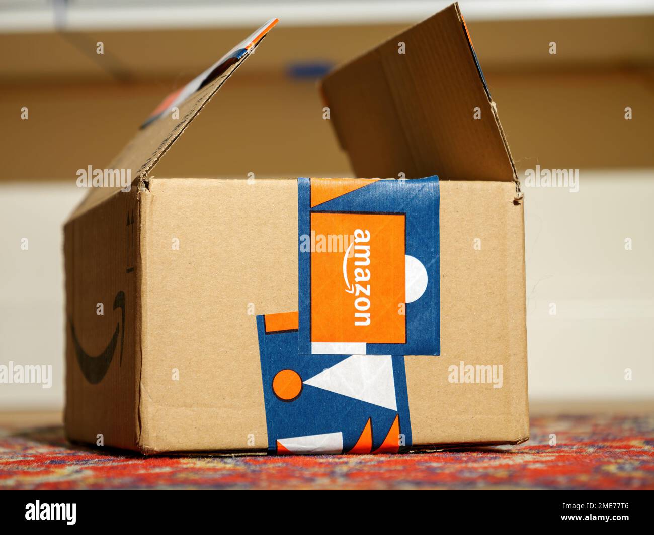 Frankfurt, Germany - Dec 2, 2022: Open Amazon winter holidays gift package parcel cardboard with dedicated scotch protection glue band Stock Photo