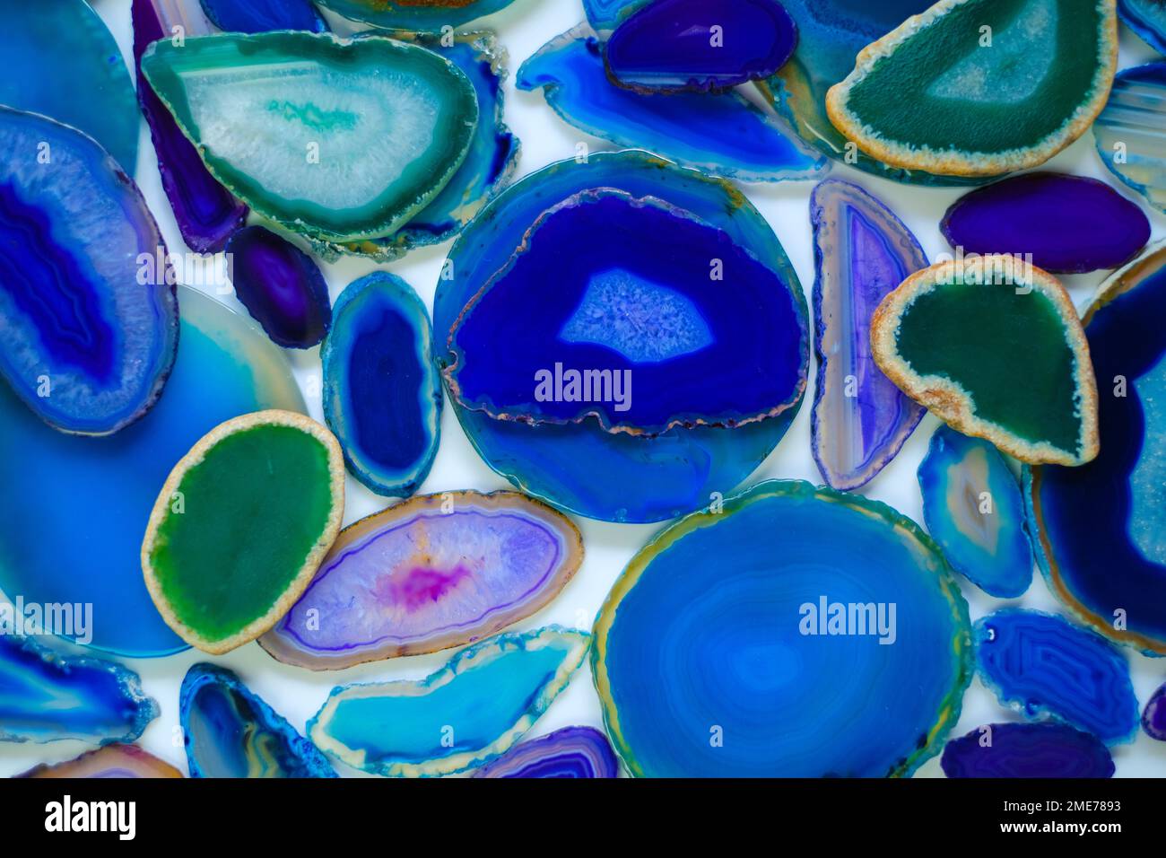 Agate geode crystal. Agates set in blue and green colors.slices of