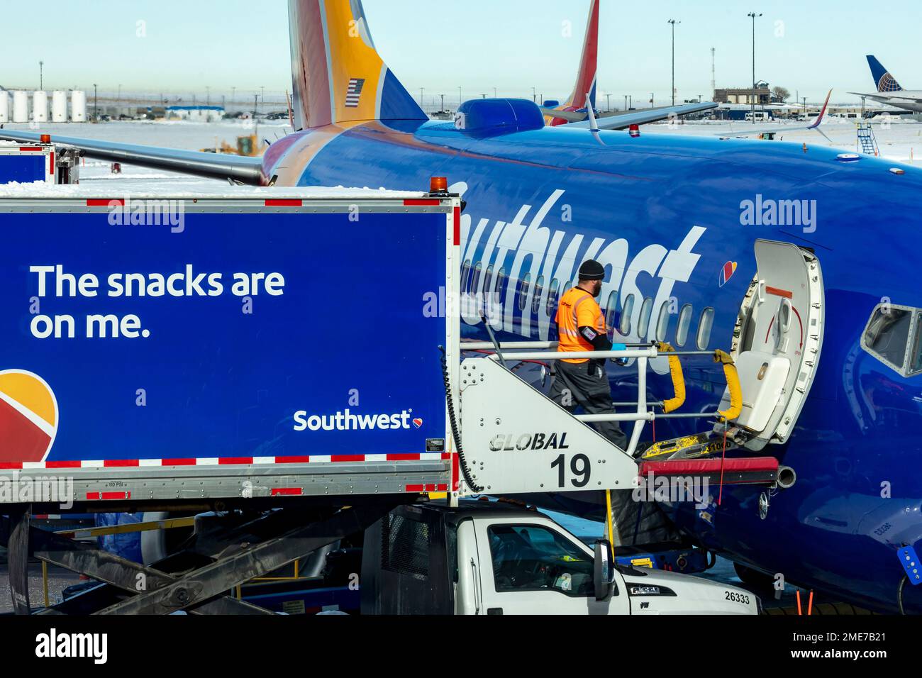 Denver, Colorado - Southwest Airlines jets on the ground after a snowstorm at Denver International Airport. A food service worker loads snacks onto a Stock Photo