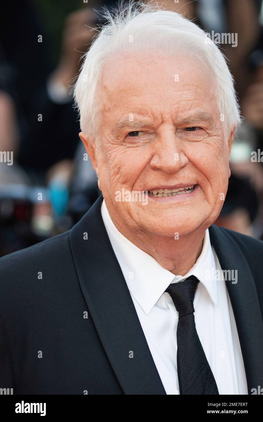 Andre Dussollier poses for photographers upon arrival at the premiere