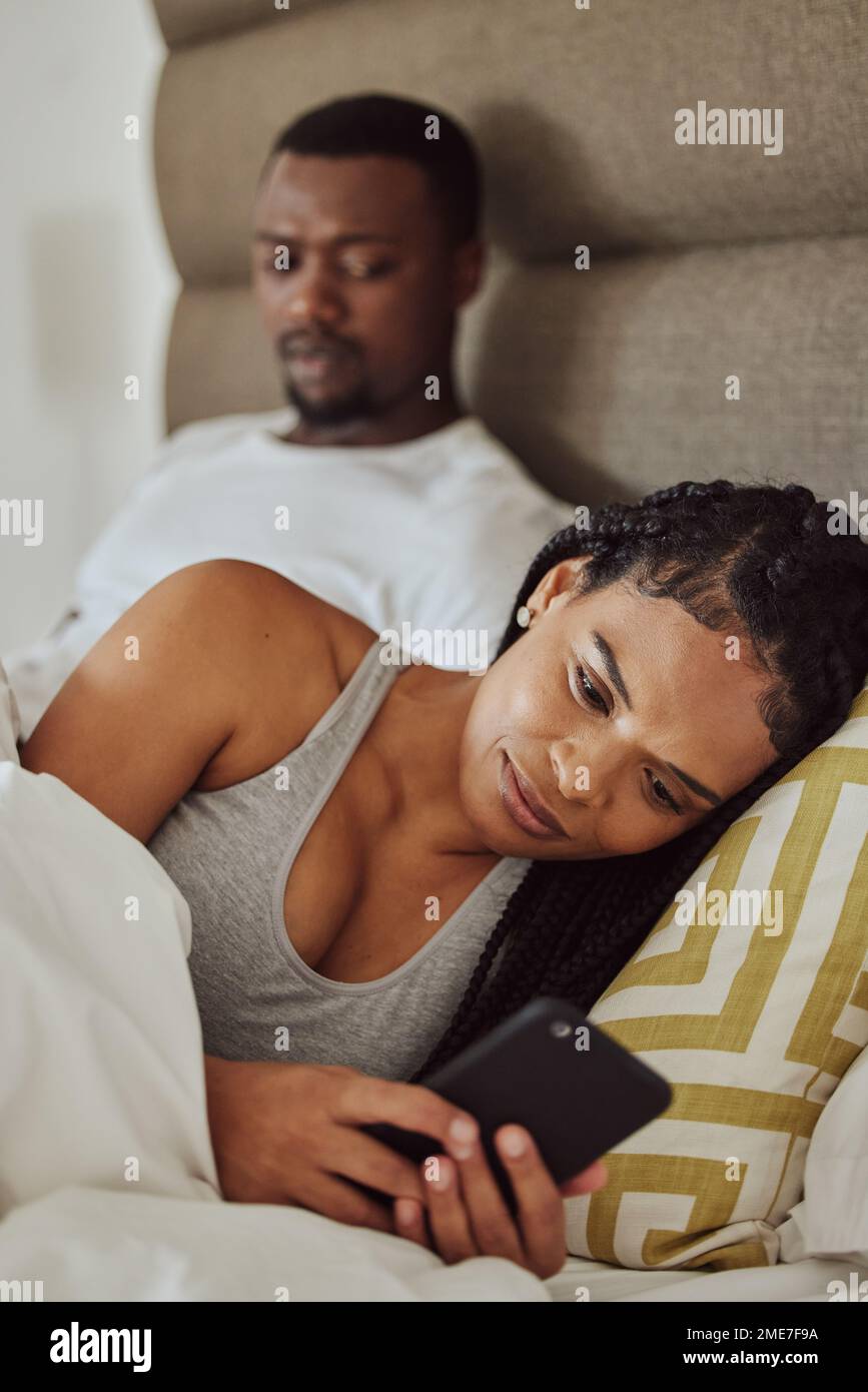 Couple in bed, black woman with smartphone and nosy man, cheating and suspicion for affair, unfaithful and infidelity