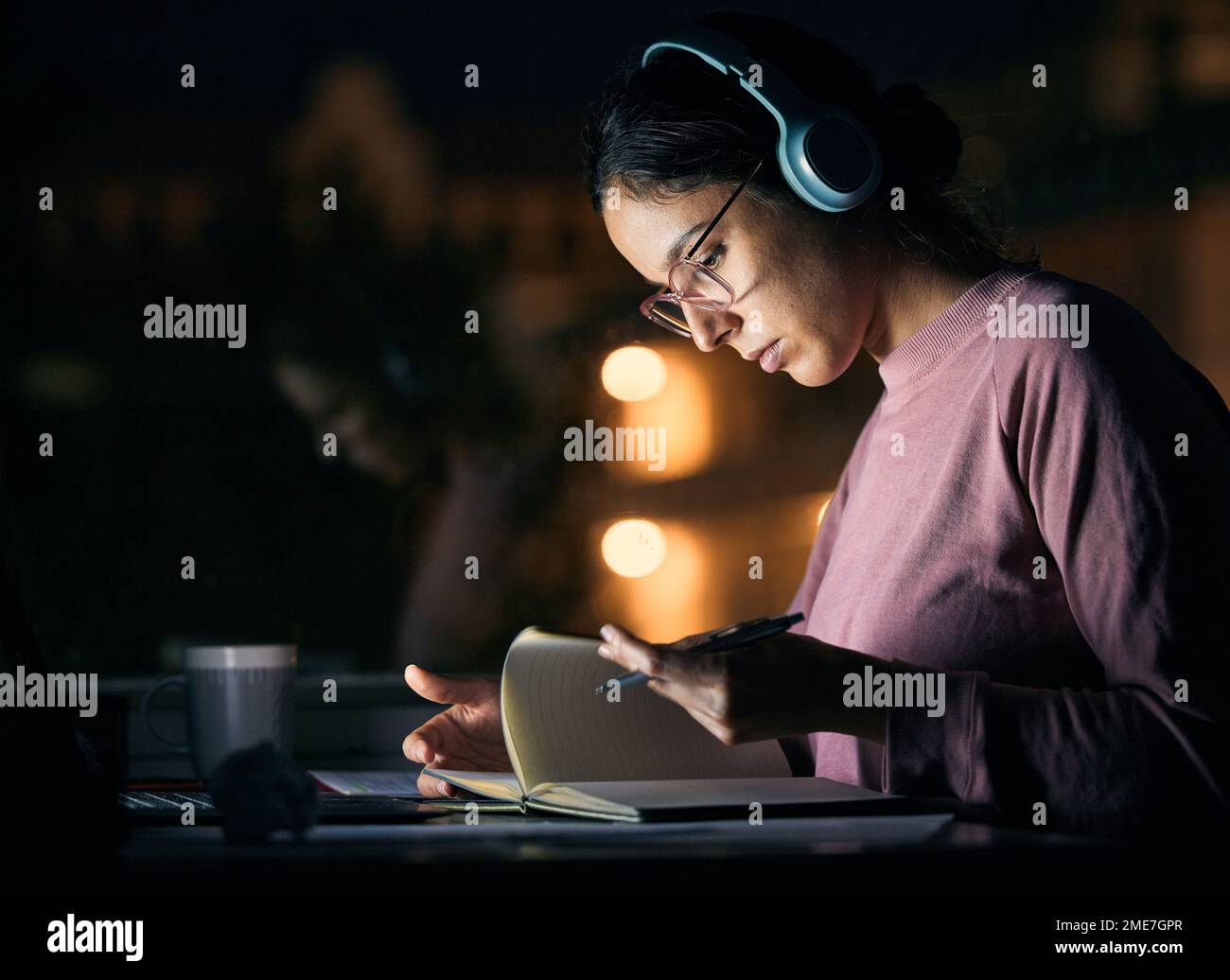 Headphones, research and girl student studying at night for a test ...