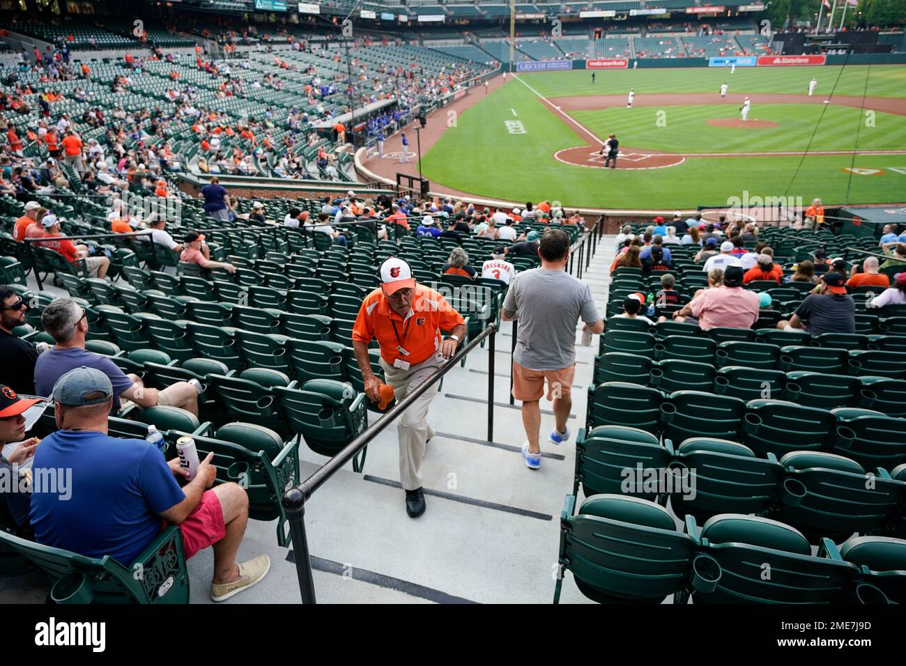 An usher walks up an isle after helping spectators to their seats