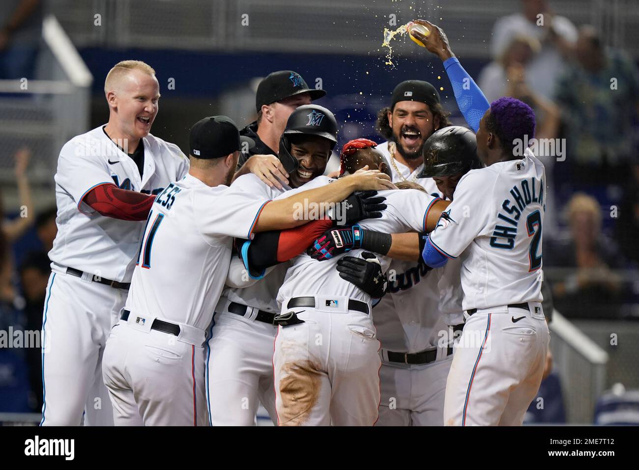 Miami Marlins' Starling Marte, center foreground, is mobbed by