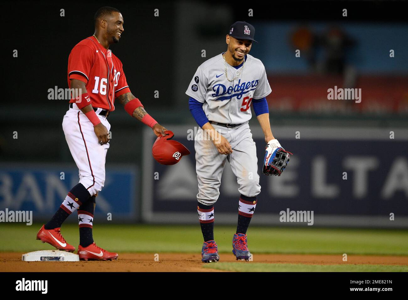 Los Angeles Dodgers right fielder Mookie Betts (50) and Washington  Nationals' Victor Robles share a laugh during a baseball game, Saturday,  July 3, 2021, in Washington. The Dodgers won 5-3.(AP Photo/Nick Wass