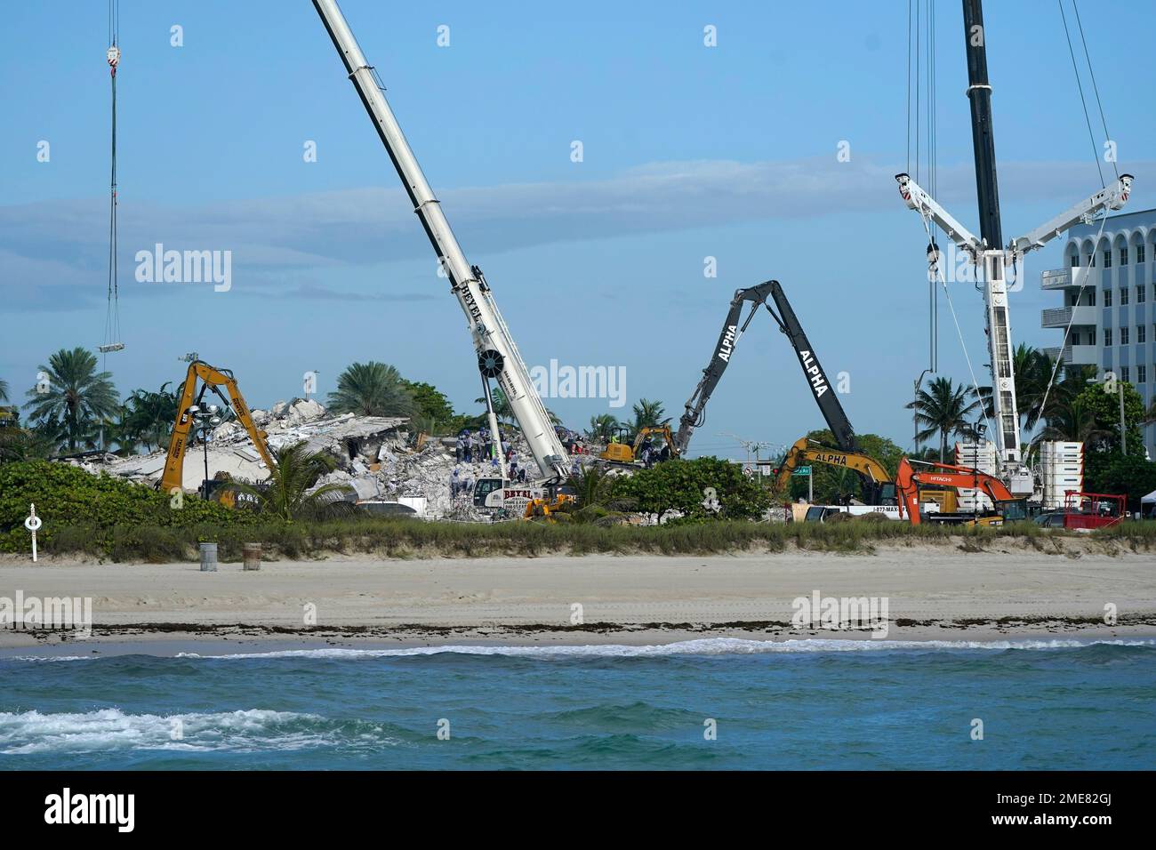 Rescue crews work at the site of the collapsed Champlain Towers South ...