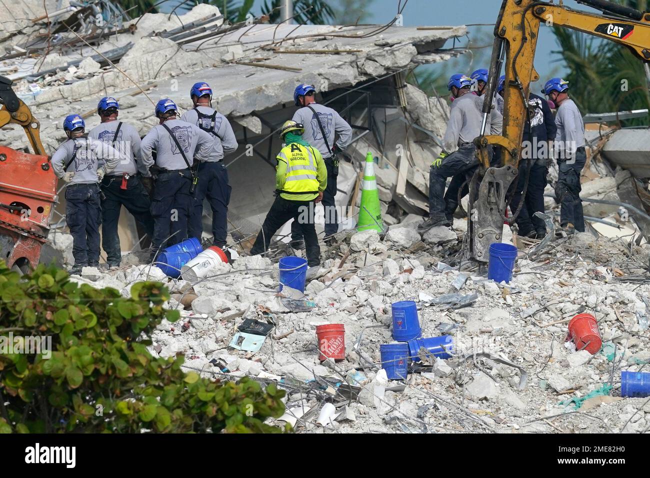 Rescue crews work at the site of the collapsed Champlain Towers South ...