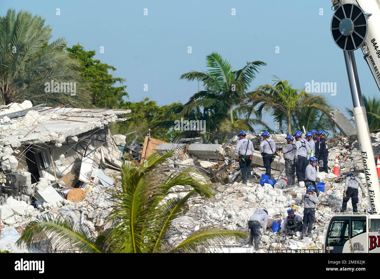 Rescue crews work at the site of the collapsed Champlain Towers South ...