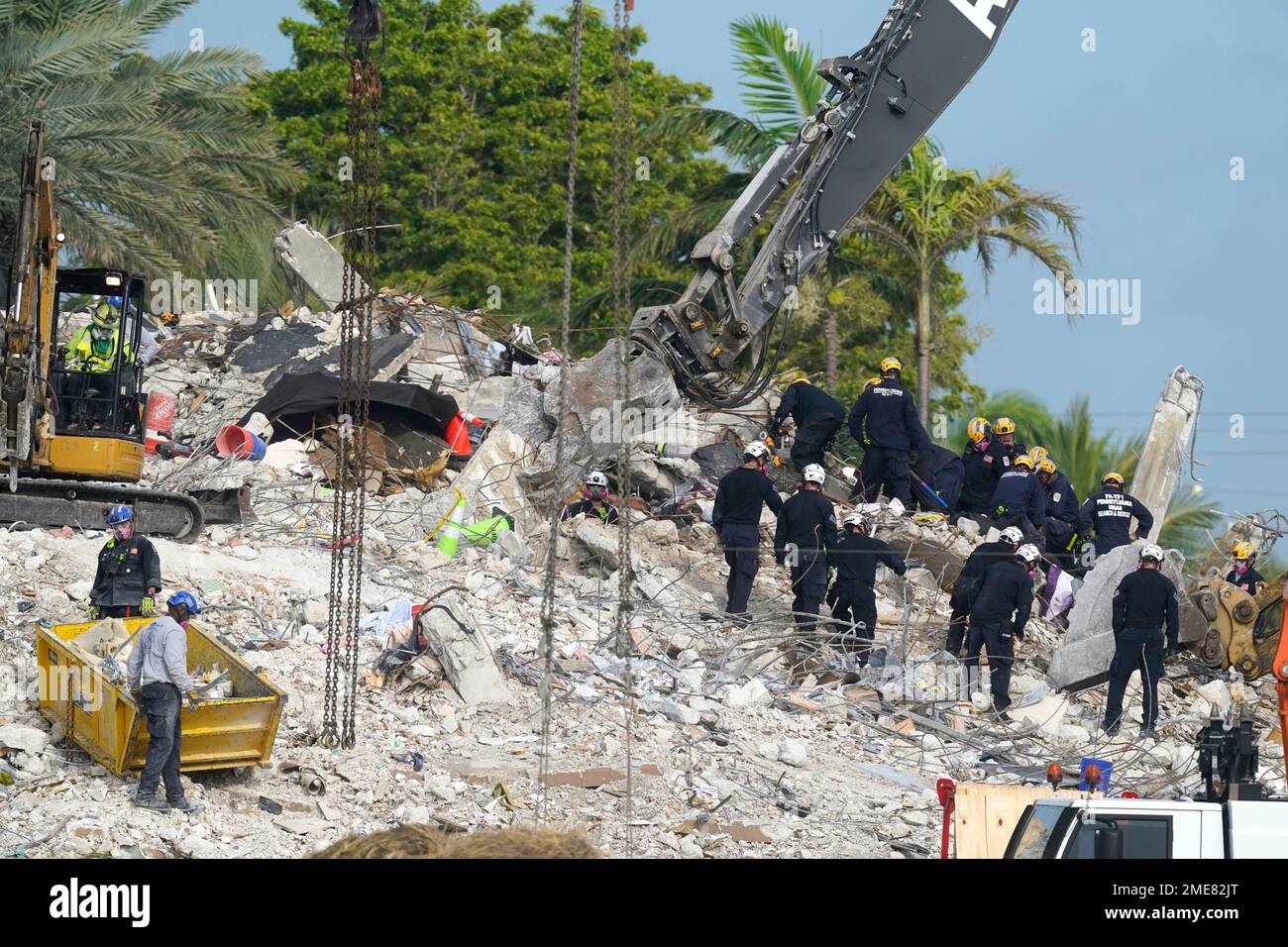 Rescue crews work at the site of the collapsed Champlain Towers South ...