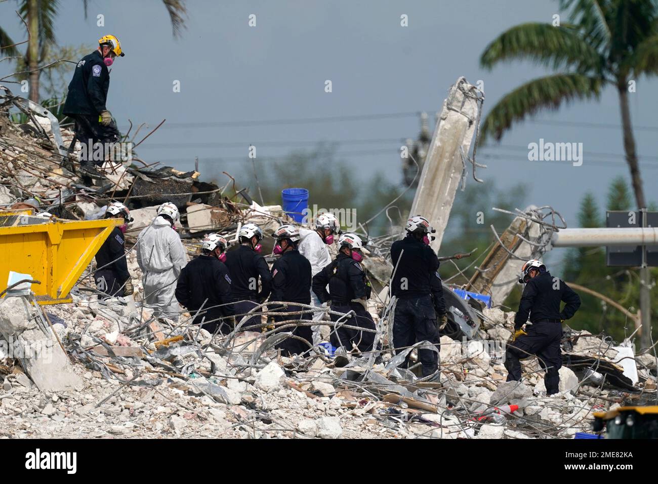Rescue crews work at the site of the collapsed Champlain Towers South ...