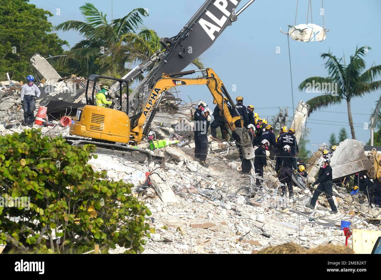 Rescue crews work at the site of the collapsed Champlain Towers South ...
