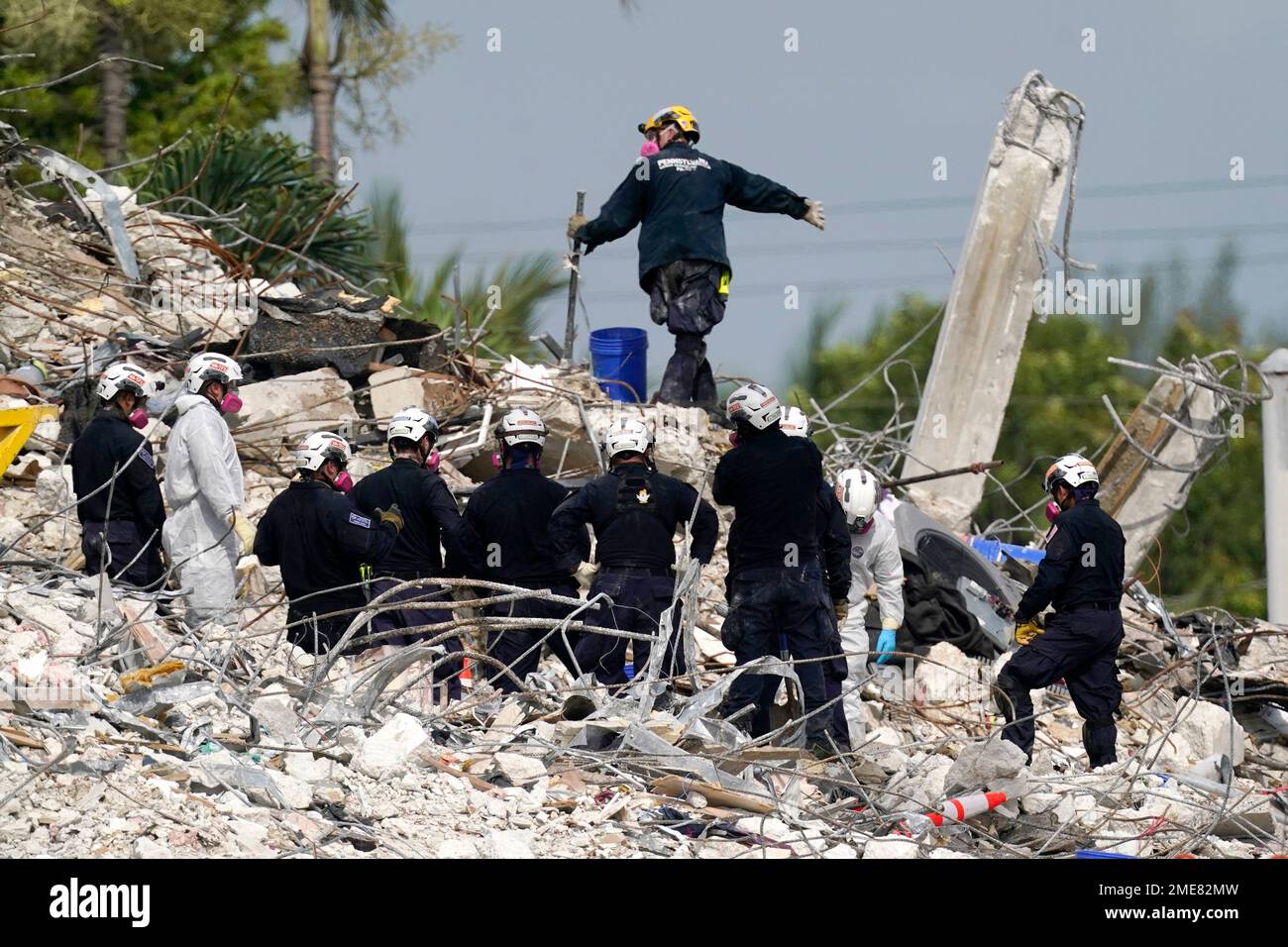 Rescue crews work at the site of the collapsed Champlain Towers South ...