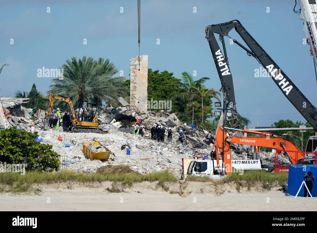 Rescue crews work at the site of the collapsed Champlain Towers South ...
