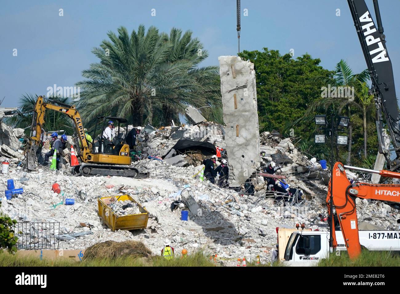 Rescue crews work at the site of the collapsed Champlain Towers South ...